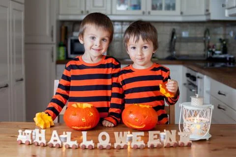 Two boys at home, preparing pumpkins for halloween Stock Photos
