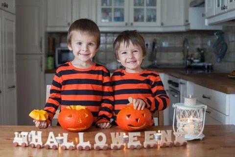 Two boys at home, preparing pumpkins for halloween Stock Photos