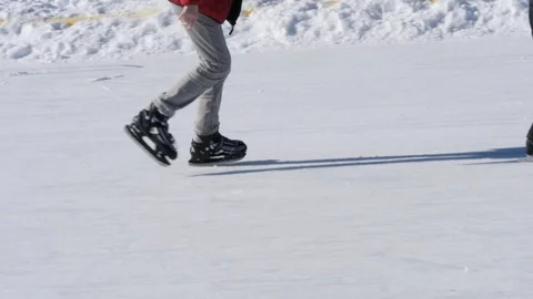 Two boys ice skate on a fun outdoor ice skating rink Stock Footage 122992048