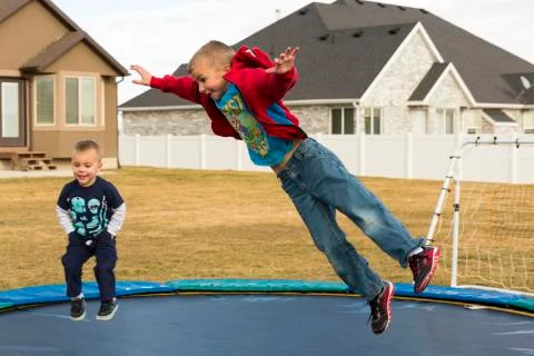 Two Boys Jumping On Trampoline Stock Photos