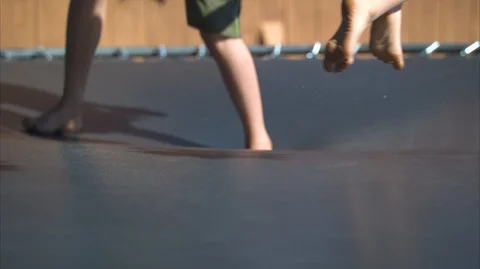 Two Boys Jumping on a Trampoline in Slow-Motion Stock Footage 94876341