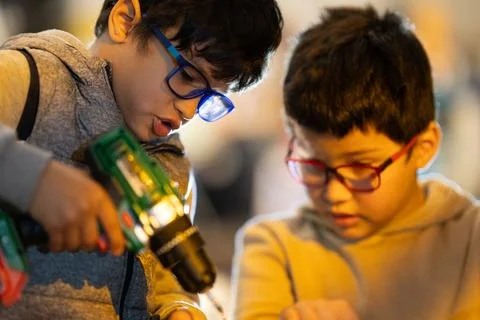 Two boys learning together using toy tools 写真素材
