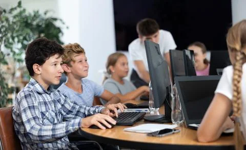 Two boys learning to work on computer in classroom 스톡 사진
