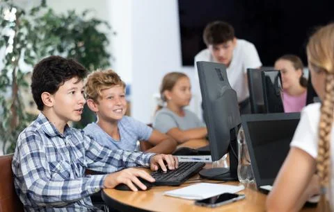 Two boys learning to work on computer in classroom Foto stock