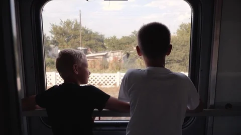 Two boys look out the window of the car ... | Stock Video | Pond5