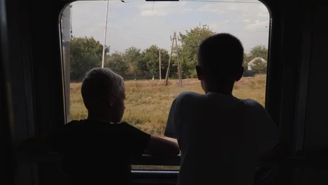Two boys look out the window of the car ... | Stock Video | Pond5