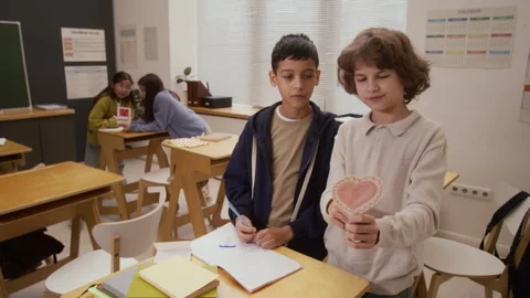 Two Boys Making Heart Shaped Valentines Cards in School Stock Footage 328329046