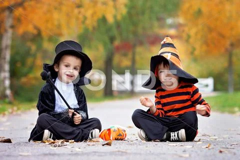 Two boys in the park with Halloween costumes Stock Photos