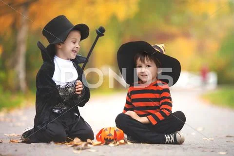 Two boys in the park with Halloween costumes Stock Photos