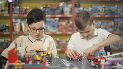 Two boys play with objects made of plastic designer Stock Footage 87959312