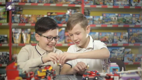 Two boys play with objects made of plastic designer Stock Footage 87959519