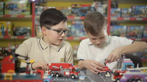 Two boys play with objects made of plastic designer Stock Footage 87959784