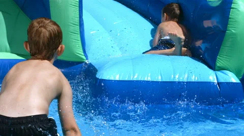 Two boys playing in pool Stock-Footage 61669665