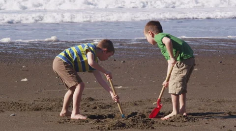 Two boys playing in sand at beach Stock-Footage 62282840