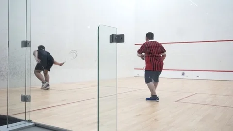 Two boys playing squash Stock Footage 121745193