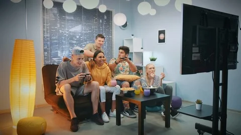 Two boys playing video console game, one of them wins Stock Footage 112458369