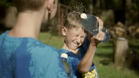 Two boys playing with water Stock Footage 98016595