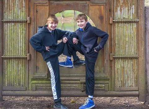 Two Boys posing in a bamboo frame in a Public Park Foto stock