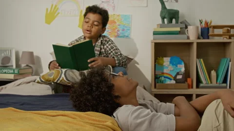 Two Boys Reading Book and Learning Together at Home Stock Footage 342505166