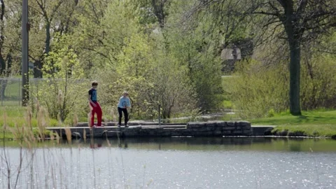 Two boys release a fish in a small lake near Grand Rapids, Michigan. 4k60p. Stock Footage 130759357