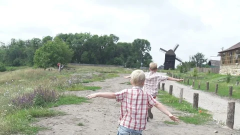 Two boys represent that they are airplanes. Children's games and dreams Stock Footage 101518960