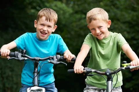 Two Boys Riding Bikes Together Stock Photos