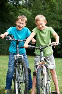 Two Boys Riding Bikes Together Stock Photos