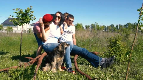 Two boys run up to their sitting parents in slow motion Stock-Footage 111188379