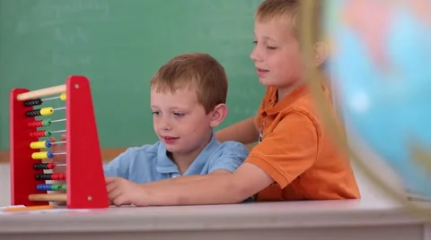 Two boys at school counting with abacus Stock-Footage 62344251