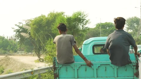 Two Boys Sitting beside Rickshaw in Indian Village Street Stock Footage 320362884
