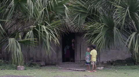 Two boys standing outside a hut in village, Guatemala Stockbeeldmateriaal 63053448