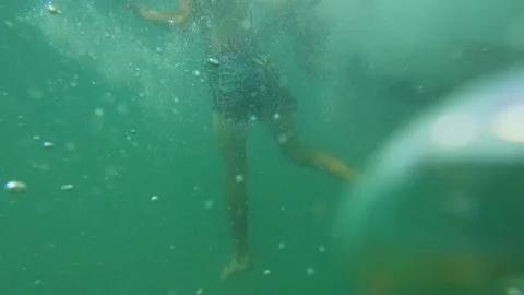 Two Boys Swimming and Playing in the Sea Water near Sandy Wild Beach Stock Footage 344549426