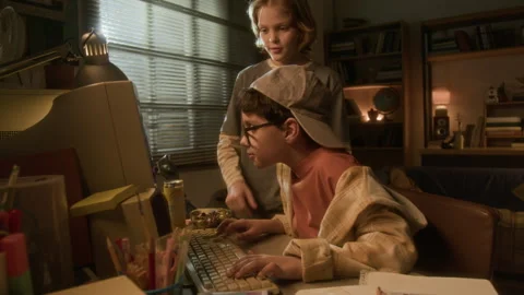 Two Boys using Computer with Friend Pointing at Screen in 90s Stock Footage 304860303