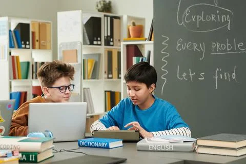 Two Boys using Computer in Library 스톡 사진