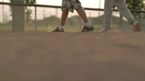 Two Boys Walk on Baseball Field Gravel Stock Footage 41670192