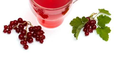 Two branches of currant and between them a juice mug Stock Photos