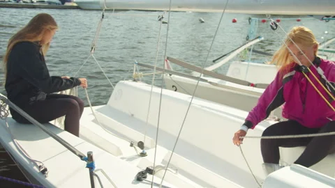 Two brave athletes are preparing for a multi-day sailing regatta on a small Stock Footage 143723911