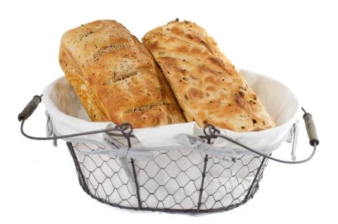 Two bread loaves in basket Stock Photos