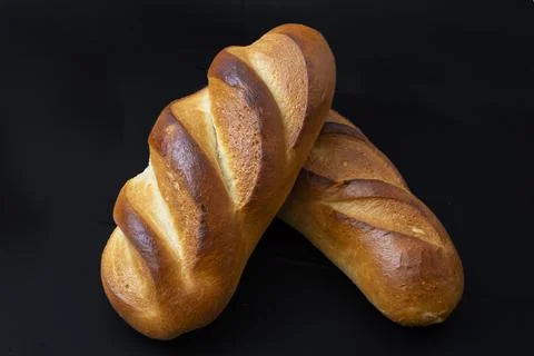Two bread loaves, isolated on black background Stock Photos