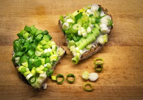 Two bread with ointment and chopped onion Stock Photos