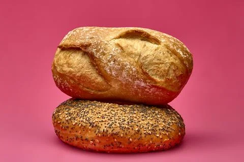 Two bread rolls stacked horizontally on pink studio background 写真素材