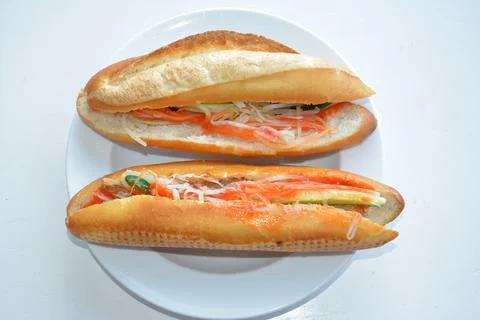 Two bread with vegetables on the white plate ready for eating Stock Photos