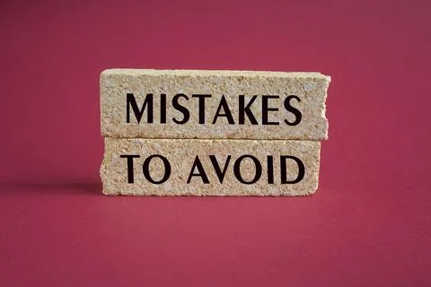 Two brick blocks with the text MISTAKES TO AVOID Stock Photos