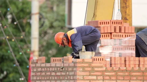 Two bricklayer building a brick wall Stock Footage 64277653