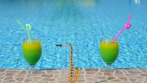 Two bright beautiful yellow-green cocktails with straws glasses, mini alt golden Video stock 147981925