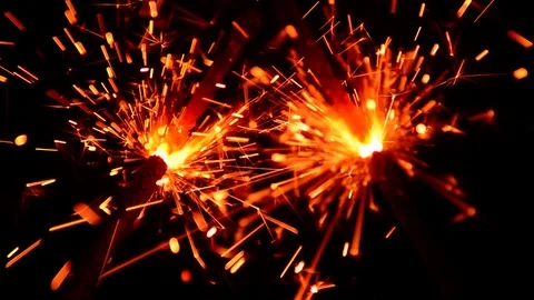 Two bright bengal lights burn on the black background close-up Stock Footage 119203134