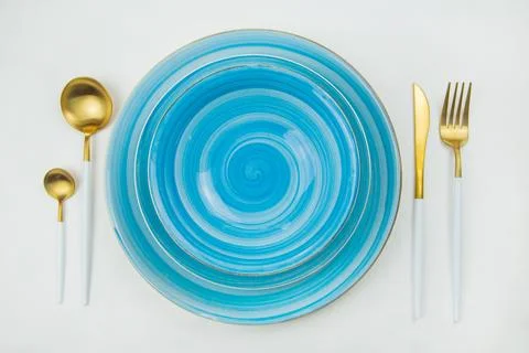 Two bright blue serving plates with a spiral pattern, gold - white serving Stock Photos
