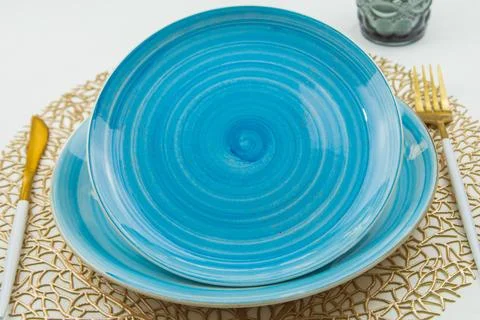 Two bright blue serving plates with a spiral pattern, one of them is tilted Foto stock