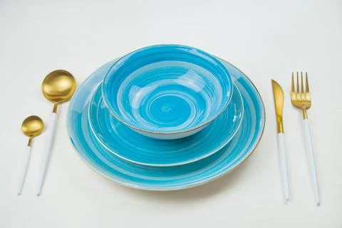 Two bright blue serving plates with a spiral pattern, gold - white serving Stock Photos