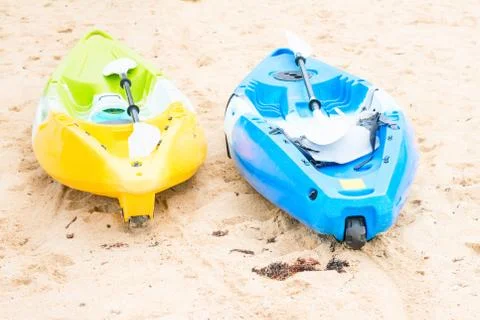 Two bright empty canoe at sand beach Stock Photos